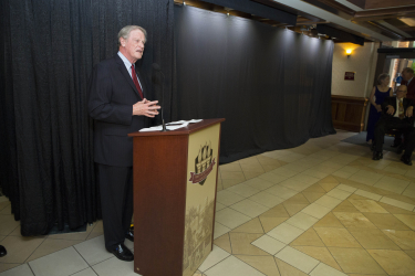 President John Thrasher addressing the crowd in front of the curtained wall