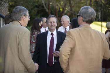 President McCullough smiling while talking with guests