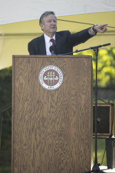 President McCullough at the podium pointing at the crowd