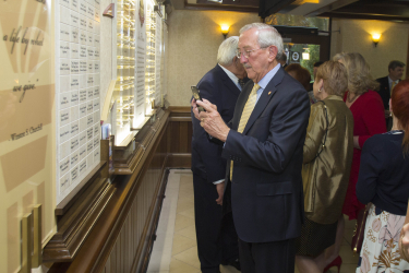 A guest takes a picture of the new donor wall with his phone